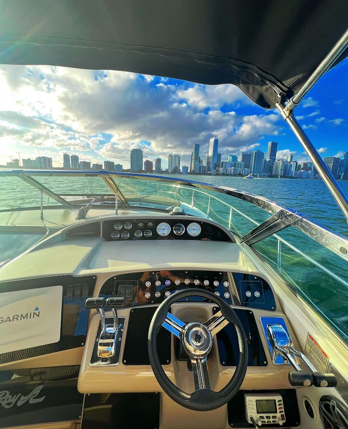 Captain's point of view from the helm of the 40 Sea Ray yacht cruising Miami Bay with the downtown Miami skyline ahead