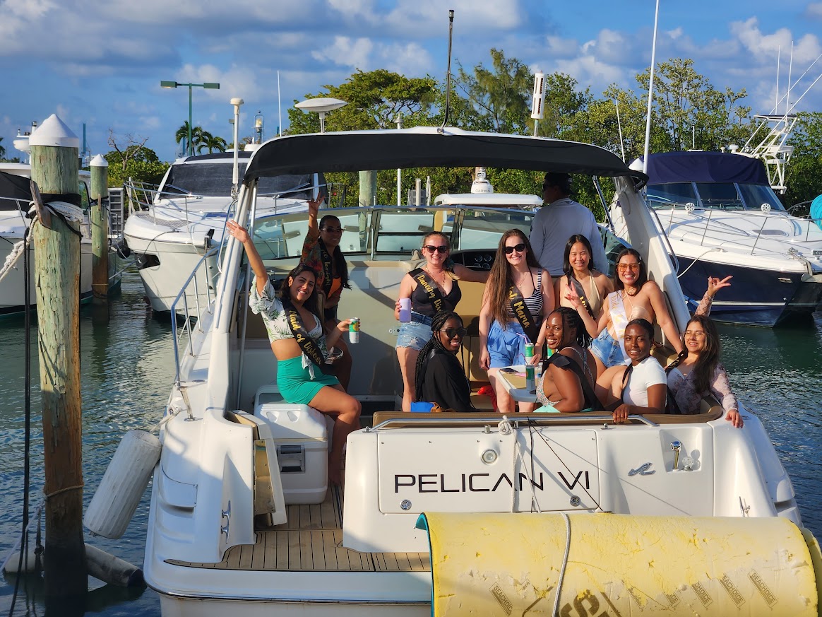 Friends enjoying an afternoon private yacht charter on the 40 Sea Ray in Miami with the bay and port in the background