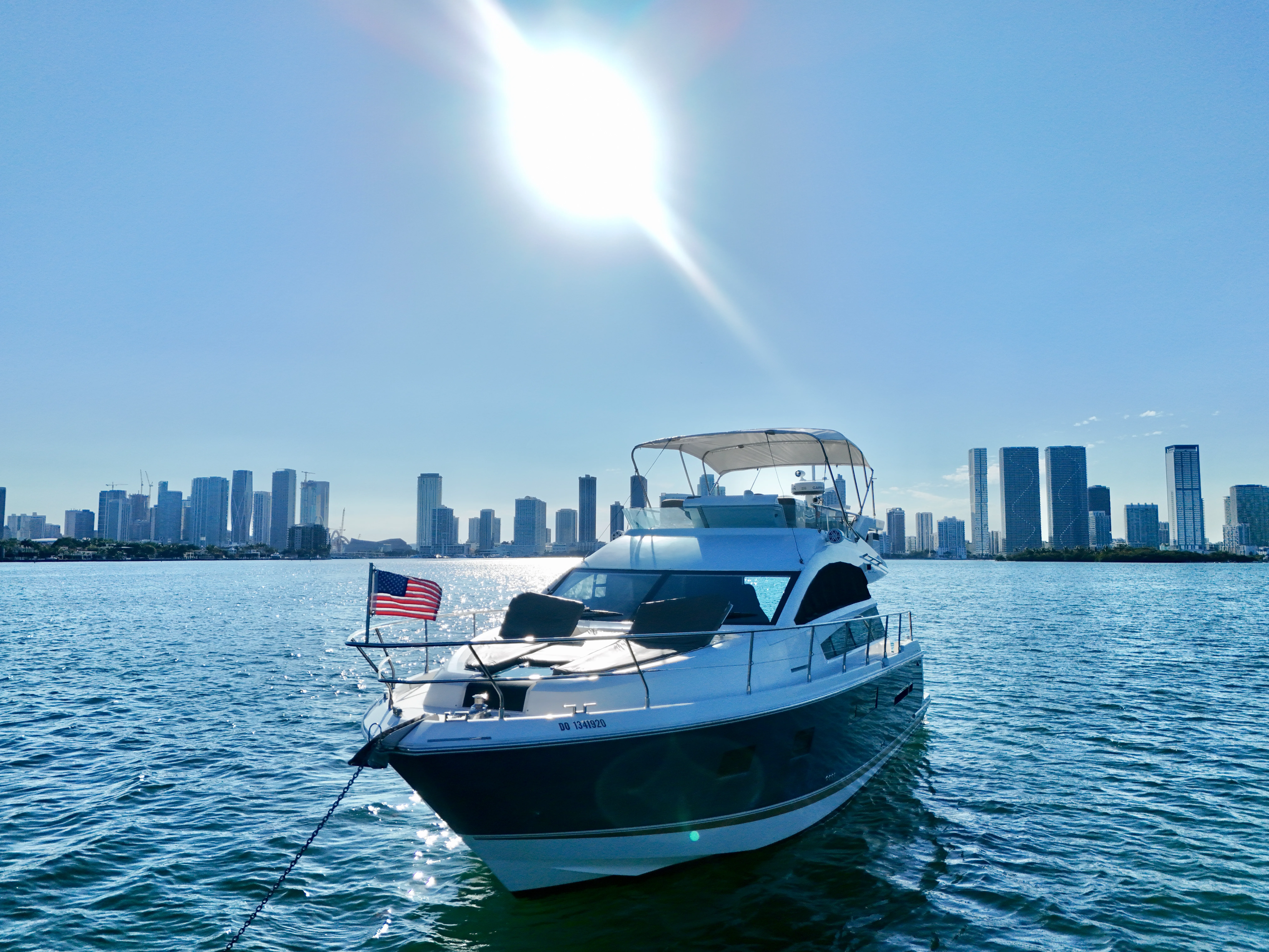 46 Flybridge sport yacht bow on Biscayne Bay, Miami — private charter with downtown skyline