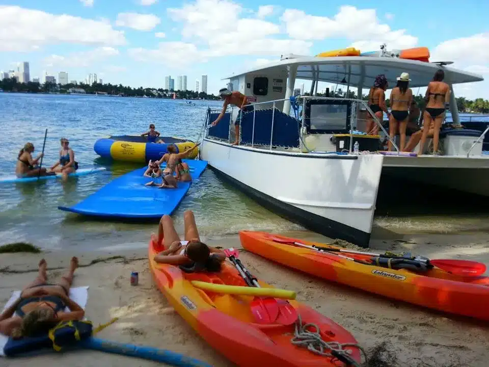 Catamaran charter guests on Biscayne Bay, Miami — island action and open deck entertaining