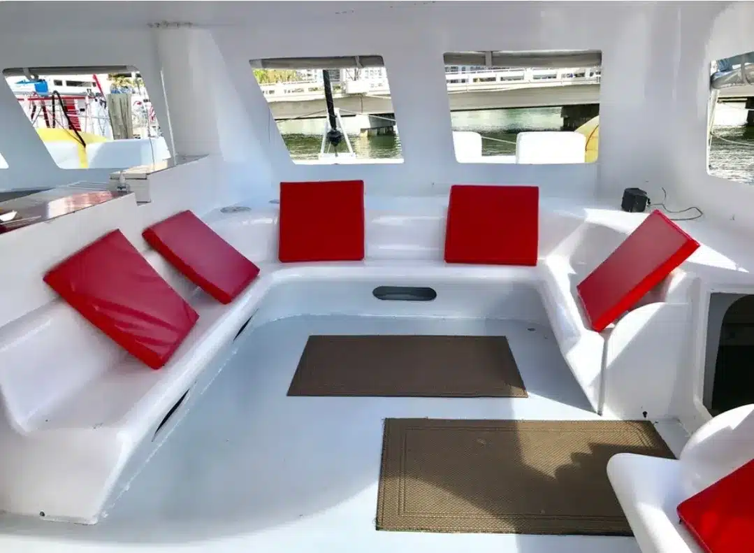 Catamaran lounge interior on MTWA Mariah — shaded salon seating for Miami crewed charters