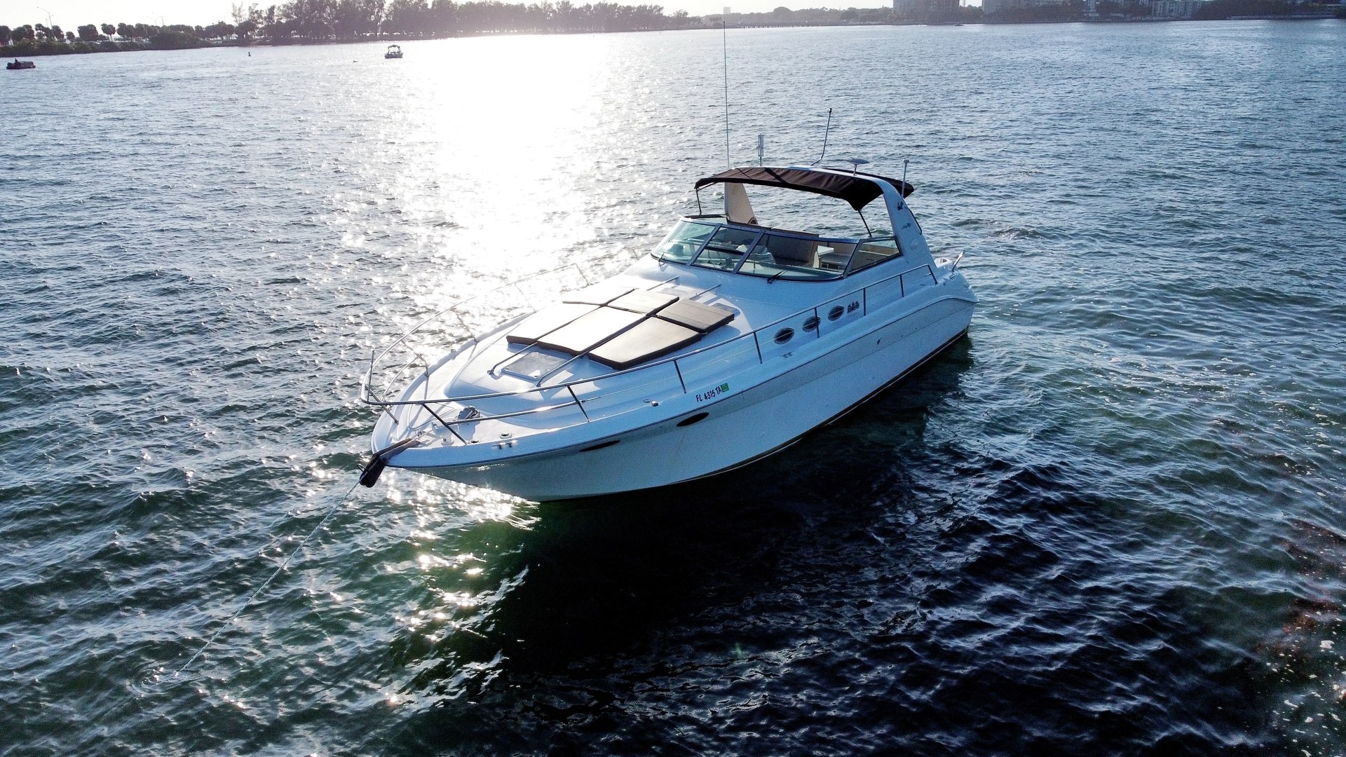 Aerial three-quarter profile of the 40 Sea Ray cruising on turquoise Biscayne Bay water