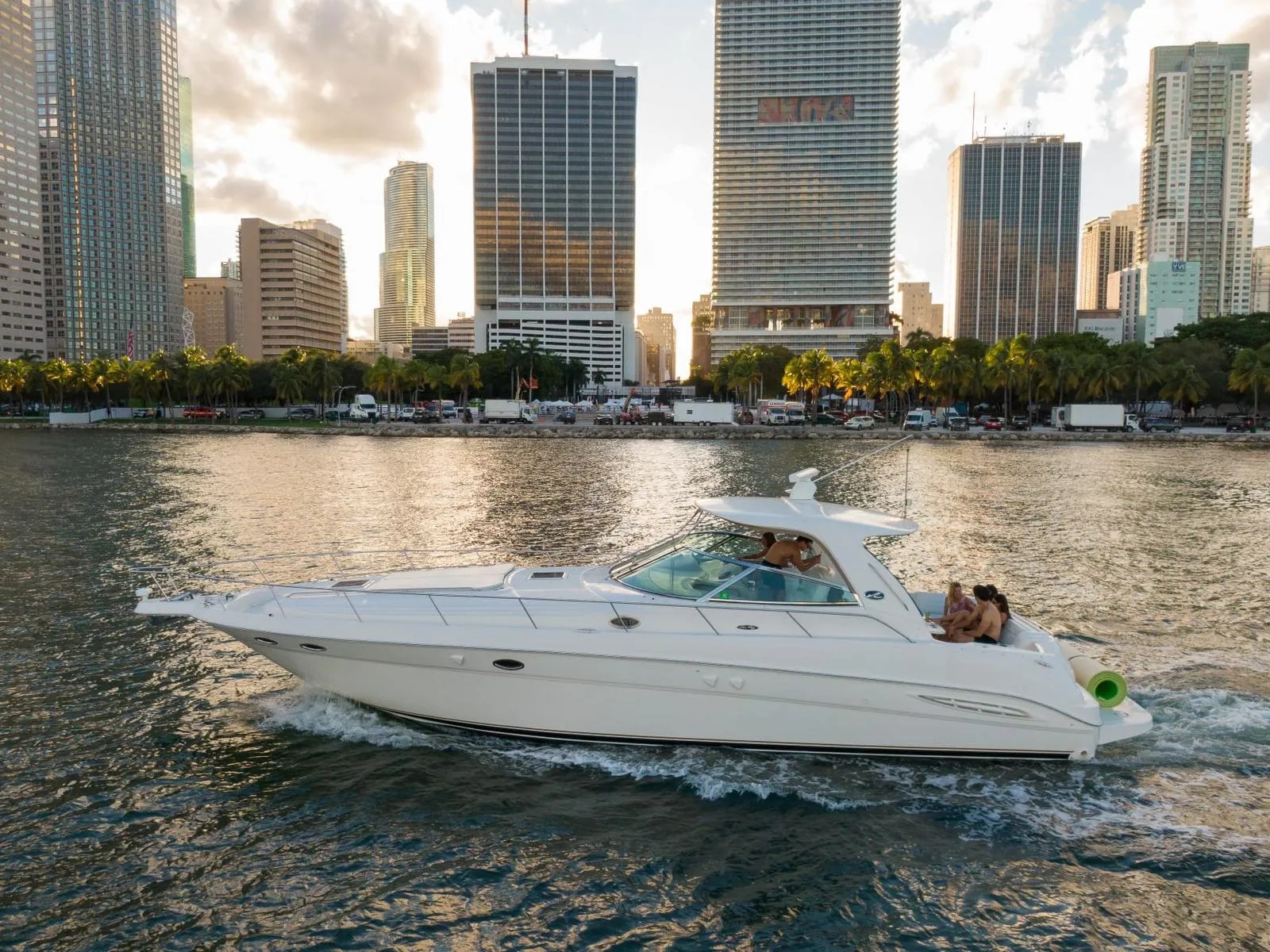 48 Sundancer sport cruiser profile with the Miami skyline behind
