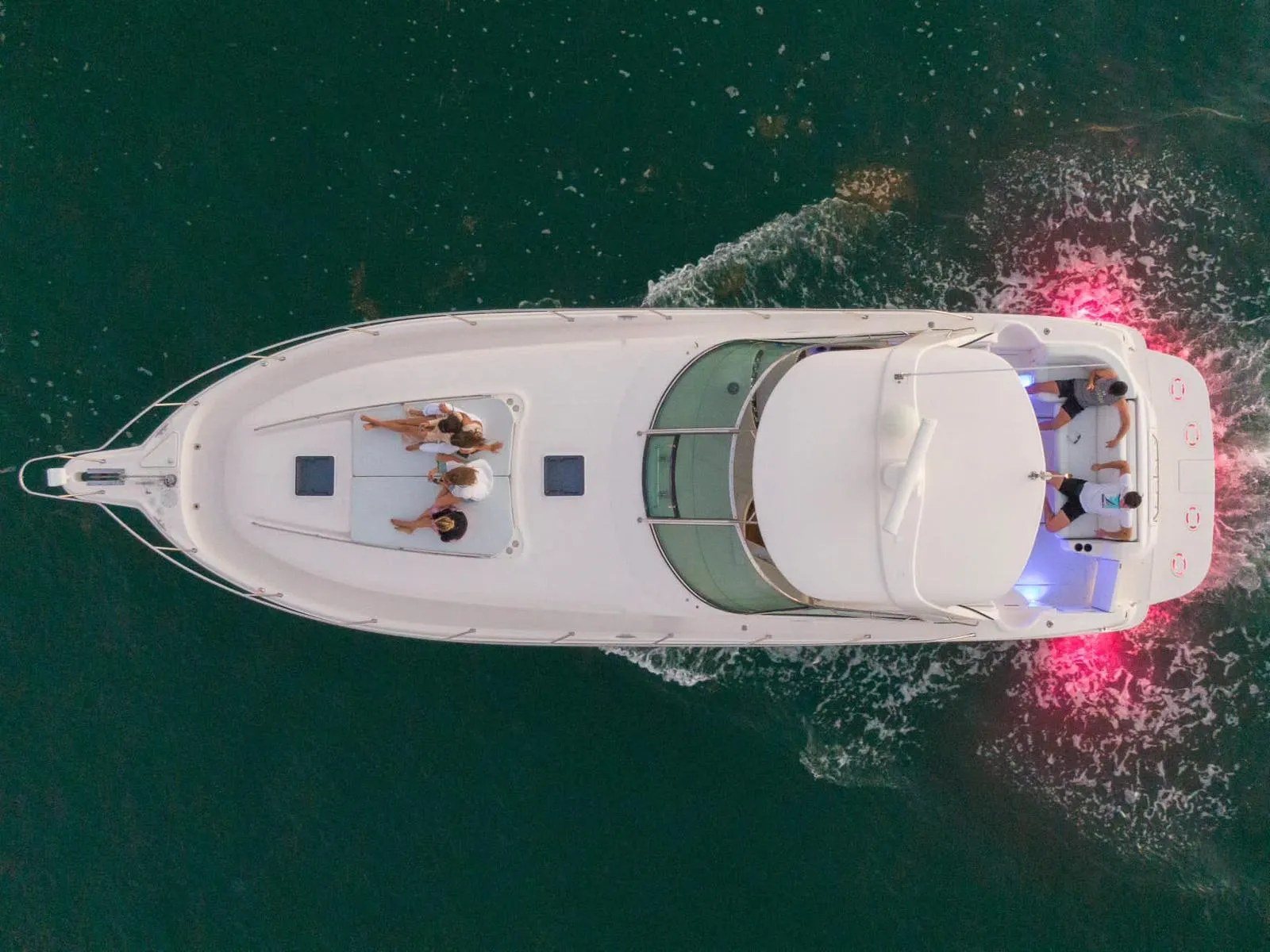 Aerial view of guests on the bow sunpad of the 48 Sundancer