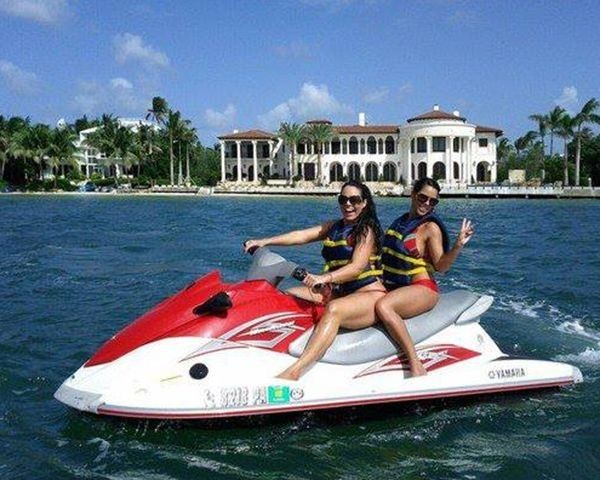 Guests riding a jet ski on open Biscayne Bay during the Ultimate Adventure Miami tour