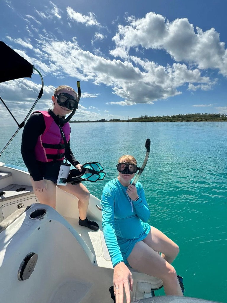 Guests fitting traditional mask and snorkel gear aboard a private Miami charter boat before departure