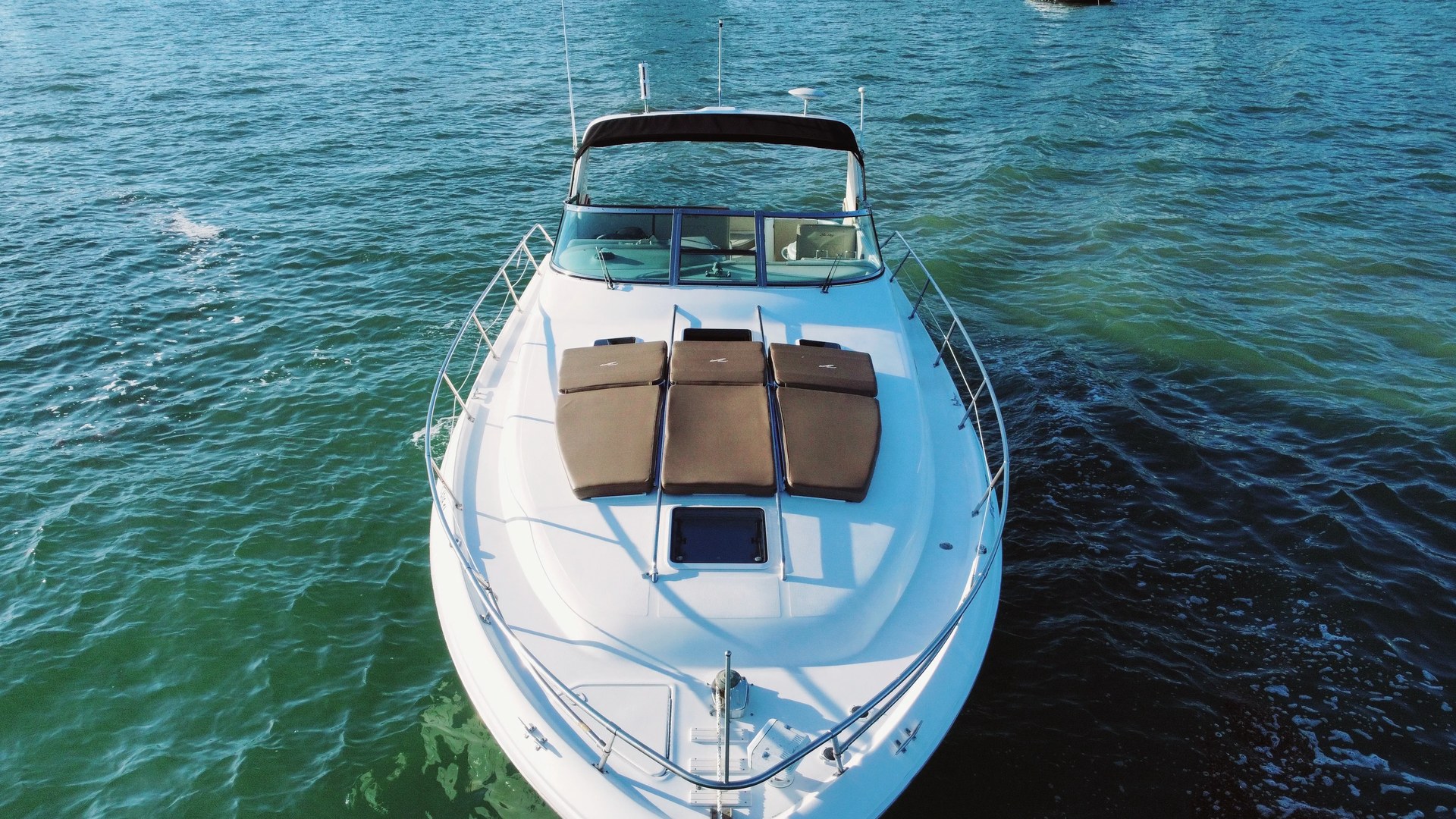 Aerial view of the 40 Sea Ray bow sunpads and stainless rail on turquoise water