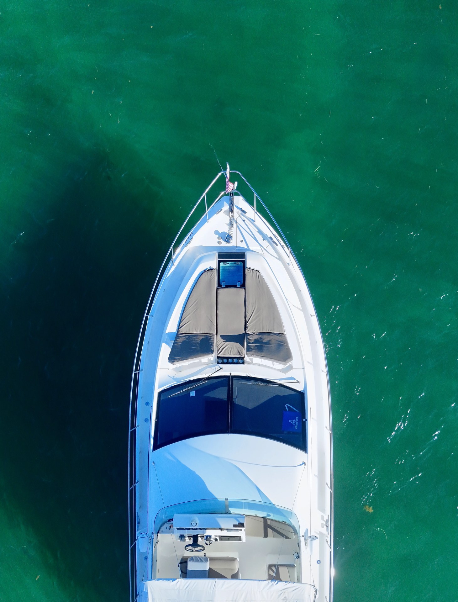 Overhead view of the 48 Sundancer bow sunpad on turquoise Biscayne Bay water