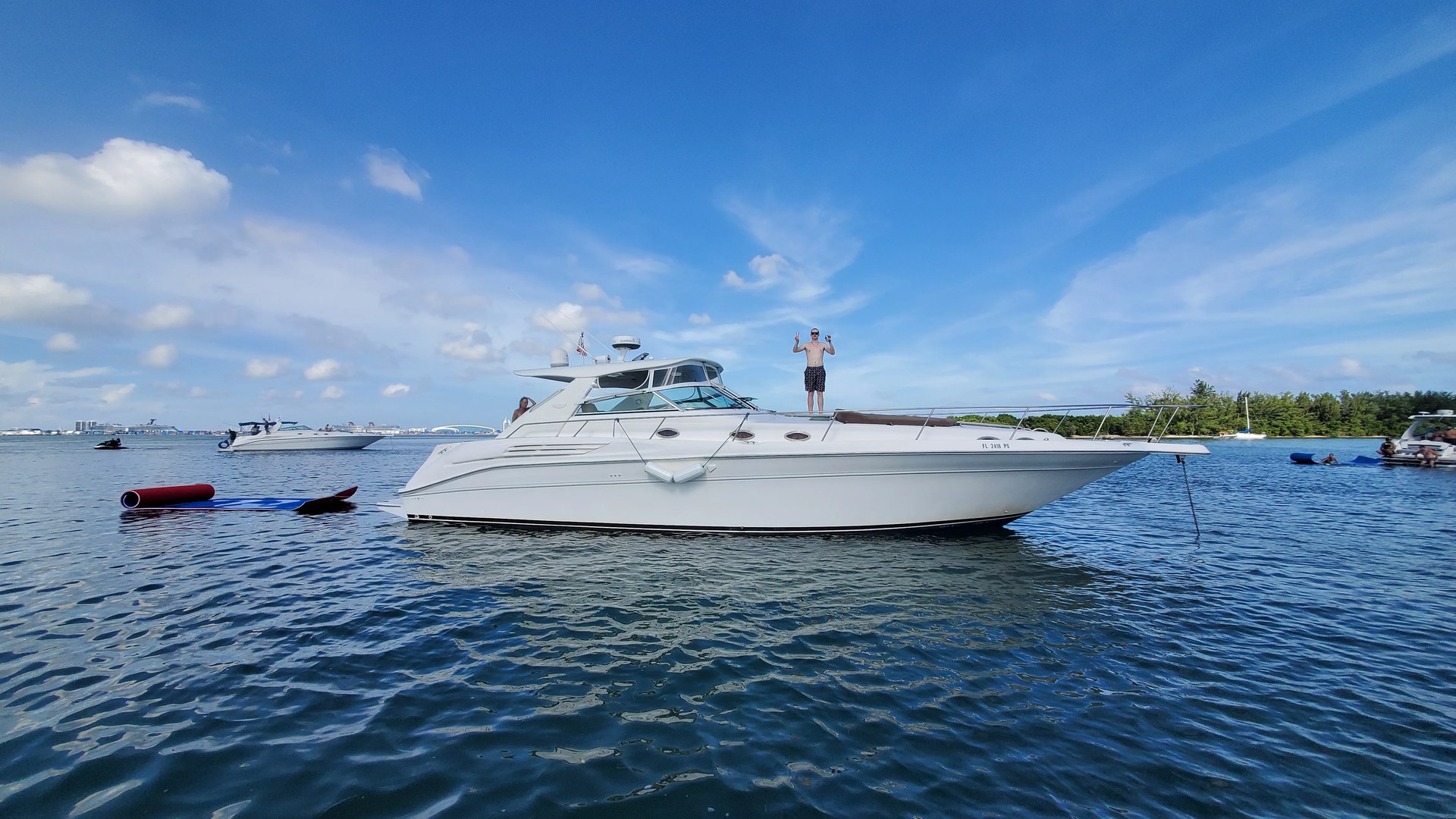 Profile of the 48 Sundancer sport cruiser on turquoise Biscayne Bay water