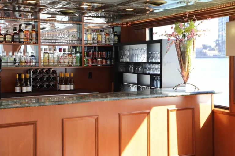 Full bar with cherry wood cabinetry on the upper deck of the 100′ Midnight Sun yacht