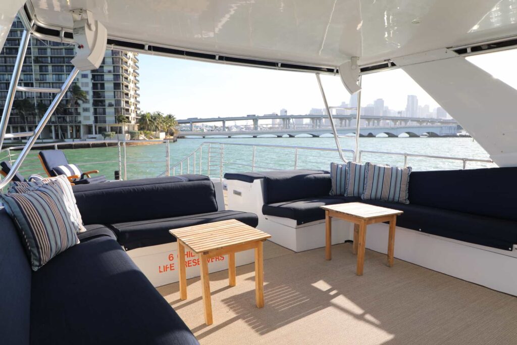 Covered flybridge deck with lounge seating on the 80 ft Solstice yacht