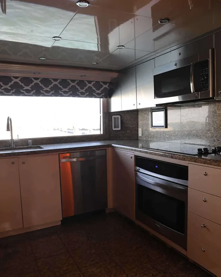 Galley on the 80′ Solstice yacht with granite counters and stainless oven, microwave and dishwasher